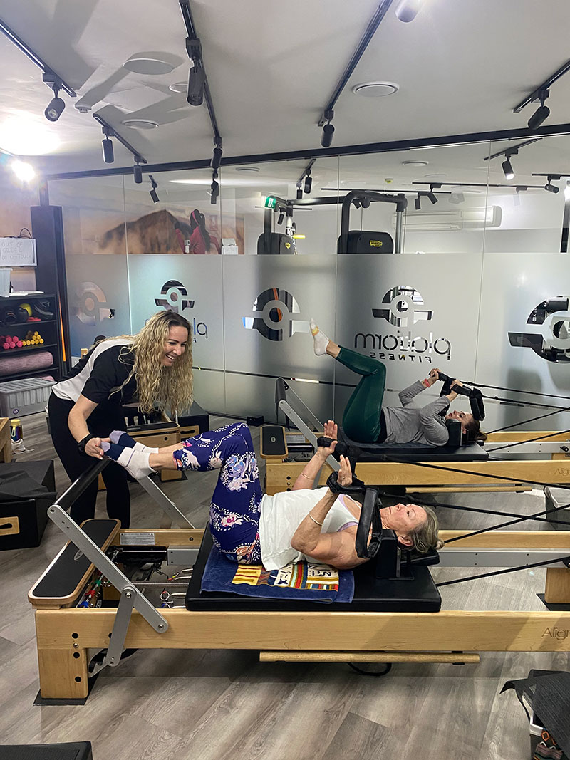 Close-up of a Reformer carriage, springs and footbar at Platform Fitness